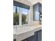 The bright kitchen features a farmhouse sink, a view to the backyard, and modern appliances at 11578 Suburban Rd, Las Vegas, NV 89135