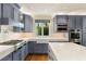 Gourmet kitchen with marble countertops, gas cooktop, custom blue cabinets and stainless steel appliances at 11578 Suburban Rd, Las Vegas, NV 89135