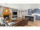 Open-concept living room connected to kitchen featuring a fireplace, tv, and hardwood floors at 11578 Suburban Rd, Las Vegas, NV 89135