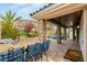 Covered patio with brick columns, outdoor seating, a grill, and access to a landscaped backyard at 11578 Suburban Rd, Las Vegas, NV 89135