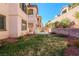 Spacious backyard with green grass, small garden area, and privacy wall, perfect for outdoor living at 11900 Calle De Sol Dr, Las Vegas, NV 89138