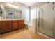 Bathroom featuring a double vanity, bathtub, and glass-enclosed shower at 11900 Calle De Sol Dr, Las Vegas, NV 89138