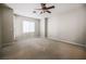 Spacious carpeted bedroom with a ceiling fan, window, and neutral paint colors at 11900 Calle De Sol Dr, Las Vegas, NV 89138