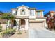 Attractive two-story home boasts a well-manicured yard, covered porch, and attached two-car garage at 11900 Calle De Sol Dr, Las Vegas, NV 89138