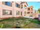 Charming two-story home with front yard featuring lush grass and colorful flower beds, inviting curb appeal at 11900 Calle De Sol Dr, Las Vegas, NV 89138