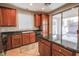 Warm kitchen featuring wood cabinets, granite counters, a center island, and sliding glass doors to the backyard at 11900 Calle De Sol Dr, Las Vegas, NV 89138