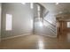 Bright, open living room with staircase, multiple windows, and tile flooring at 11900 Calle De Sol Dr, Las Vegas, NV 89138