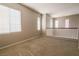 Large carpeted loft space with neutral paint, large window, and railing overlooking the floor below at 11900 Calle De Sol Dr, Las Vegas, NV 89138