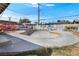 View of the home's backyard featuring a graffiti-covered fence surrounding an in-ground skate pool at 121 N 20Th St, Las Vegas, NV 89101