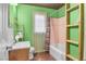 The clean bathroom with a sink, toilet, and tub-shower combo showcases efficiency and utility in a compact space at 121 N 20Th St, Las Vegas, NV 89101