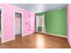 Colorful bedroom with wood flooring, closet and window providing ample natural light, and vibrant design at 121 N 20Th St, Las Vegas, NV 89101