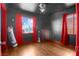 Bedroom with two windows, wood floors, dark walls, and a view of the outdoors through the windows at 121 N 20Th St, Las Vegas, NV 89101