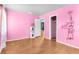 This is a pink bedroom featuring an open closet, water heater, and a unique design, making it charming at 121 N 20Th St, Las Vegas, NV 89101