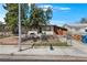 Modest single-story home featuring a chain-link fence and mature trees at 121 N 20Th St, Las Vegas, NV 89101