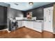 This kitchen has white cabinetry, an electric oven and range, and stainless steel washer and dryer set at 121 N 20Th St, Las Vegas, NV 89101