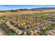 An aerial view of a home and neighborhood that highlight its location, surrounding homes, and nearby mountains at 12219 Crystal Shore Ave, Las Vegas, NV 89138
