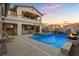 This backyard offers a stunning pool, spa, rock waterfall, and outdoor seating at 12219 Crystal Shore Ave, Las Vegas, NV 89138