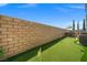 Well-maintained backyard with artificial grass, a putting green, and outdoor BBQ at 12219 Crystal Shore Ave, Las Vegas, NV 89138