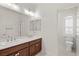 Bright bathroom featuring double sinks with granite countertops and tiled flooring at 12219 Crystal Shore Ave, Las Vegas, NV 89138
