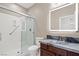 Bathroom features a shower with glass doors, granite countertops and a lighted mirror at 12219 Crystal Shore Ave, Las Vegas, NV 89138