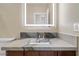 Bathroom vanity features granite countertops and a lighted mirror at 12219 Crystal Shore Ave, Las Vegas, NV 89138