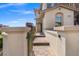 Inviting walkway to the front door surrounded by lush landscaping and privacy walls at 12219 Crystal Shore Ave, Las Vegas, NV 89138