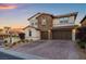 Elegant two-story home with a three-car garage and stone accents, creating a sophisticated look at 12219 Crystal Shore Ave, Las Vegas, NV 89138