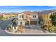 Charming two-story home with a well-manicured front yard, brick driveway, and a three-car garage in a quiet neighborhood at 12219 Crystal Shore Ave, Las Vegas, NV 89138