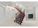 Elegant foyer with staircase, statement chandelier, and a modern fireplace at 12219 Crystal Shore Ave, Las Vegas, NV 89138