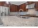 Kitchen features stainless steel appliances, granite countertops, and island sink at 12219 Crystal Shore Ave, Las Vegas, NV 89138