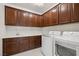 Laundry room featuring modern washer and dryer, storage cabinets and granite countertops at 12219 Crystal Shore Ave, Las Vegas, NV 89138