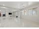 Open-concept living room with fireplace and shuttered windows at 12219 Crystal Shore Ave, Las Vegas, NV 89138