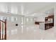 Open living area with staircase and kitchen island in the background at 12219 Crystal Shore Ave, Las Vegas, NV 89138