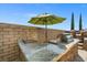 Built-in outdoor kitchen with granite countertop and stone accents at 12219 Crystal Shore Ave, Las Vegas, NV 89138