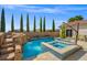 Backyard oasis featuring a pool, spa, and waterfall at 12219 Crystal Shore Ave, Las Vegas, NV 89138