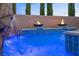 Stunning pool featuring a rock waterfall, fire bowls, and pristine blue water at 12219 Crystal Shore Ave, Las Vegas, NV 89138