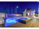 Nighttime view of pool and spa with waterfall and fire bowls for a calming outdoor atmosphere at 12219 Crystal Shore Ave, Las Vegas, NV 89138