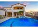 Beautiful pool area with spa, waterfall, lush landscaping, and ample seating for outdoor enjoyment at 12219 Crystal Shore Ave, Las Vegas, NV 89138