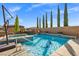 Stunning backyard pool features a spa, rock waterfall, and plenty of space for entertaining at 12219 Crystal Shore Ave, Las Vegas, NV 89138