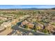 An elevated shot capturing the neighborhood's layout, featuring neat rows of houses with red-tiled roofs along winding roads at 12219 Crystal Shore Ave, Las Vegas, NV 89138