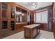 Expansive walk-in closet featuring custom cabinetry and a granite topped island at 12219 Crystal Shore Ave, Las Vegas, NV 89138