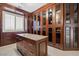 Custom walk-in closet with granite island and ample storage with glass door cabinets at 12219 Crystal Shore Ave, Las Vegas, NV 89138