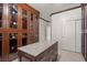 Well-organized walk-in closet with central island, custom cabinets and granite countertop at 12219 Crystal Shore Ave, Las Vegas, NV 89138