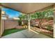 Charming covered patio features a landscaped backyard with mature trees and plants at 1435 Orange Jubilee Rd, Henderson, NV 89014