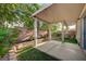 Relaxing covered back patio with a mix of concrete and artificial turf, and beautiful landscaping at 1435 Orange Jubilee Rd, Henderson, NV 89014