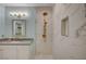 Bathroom with modern vanity, round mirror, and marble tile shower at 1435 Orange Jubilee Rd, Henderson, NV 89014