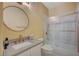Bathroom featuring a white vanity, round mirror, and glass enclosed shower/tub combo at 1435 Orange Jubilee Rd, Henderson, NV 89014