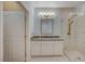 Beautiful bathroom with herringbone tile floor, white vanity, and glass enclosed shower at 1435 Orange Jubilee Rd, Henderson, NV 89014