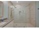 Walk-in shower with sleek glass enclosure, rainfall showerhead and marble tile at 1435 Orange Jubilee Rd, Henderson, NV 89014