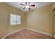 Bright bedroom featuring wood-look flooring, a window with blinds, and a fresh, minimalist aesthetic at 1435 Orange Jubilee Rd, Henderson, NV 89014